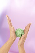 Rolling spiky ball between hands to reduce stress