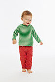 Little boy in green stripey top playing