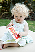 Baby girl reading book