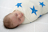 Baby boy swaddled in blanket