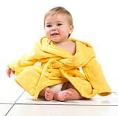 Baby girl wearing yellow dressing gown
