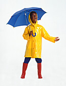 Boy in raincoat carrying umbrella