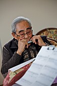 Elderly man playing harmonica, Fukushima, Japan