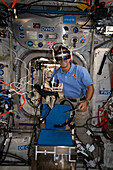 NASA astronaut wearing virtual reality goggles on the ISS