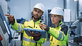 Engineer and manager talking in a factory