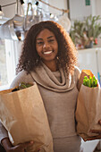 Happy young woman with grocery bags