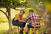 Couple taking a break from gardening at table