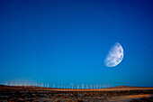 Moon over windmills in the desert