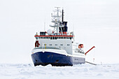 Research icebreaker docked over an ice floe