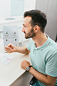 Man selecting hearing aid at hearing clinic
