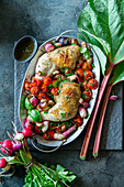 Roast chicken roasted with rhubarb, tomatoes and radishes