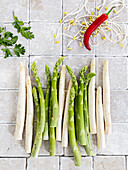 White and green asparagus spears, a chilli pepper and bean sprouts