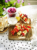 Lemony hake bell pepper kebabs with red cabbage and Tzatzika