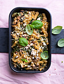 Vegan noodle casserole with spinach, mushrooms, and tofu topping