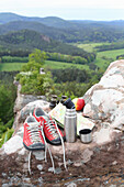 Hiking boots, thermos flask and apple (for hikes)