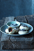 Mini-yeast dumplings with plum filling and poppy seeds