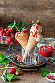 Ice cream cones with strawberry sauce