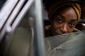 Young woman in car window