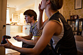 Teenage boys playing video game at home