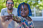 Curious toddler girl with blue braids