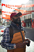Mature male tourist on sunny city street