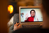 Businesswoman on laptop screen waving in video conference