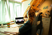 Woman video conferencing with colleagues