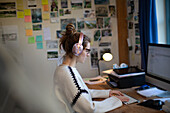 Woman with headphones working from home