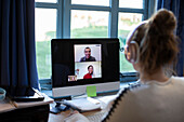 Woman video conferencing with colleagues