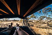 Couple relaxing in tent in remote landscape, Australia