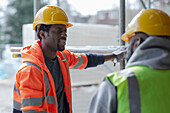 Construction workers talking at construction site