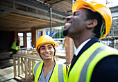 Happy construction workers talking at construction site