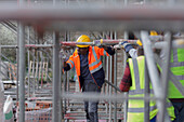 Construction worker assembling scaffolding