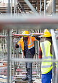 Construction workers assembling scaffolding
