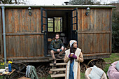 Couple enjoying coffee outside tiny cabin rental