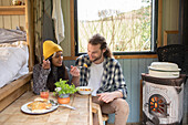 Young couple enjoying lunch in tiny cabin rental