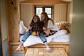 Happy young couple relaxing with coffee in bed