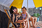 Granddaughter with grandmother at summer poolside