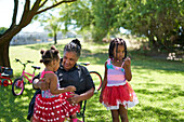 Grandmother and granddaughters in park