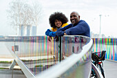 Happy father and son on urban footbridge