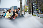 Young female friends talking in city