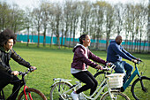 Happy family riding bicycles in park