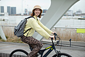 Young woman riding bicycle in city
