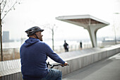 Man riding bicycle on urban boardwalk