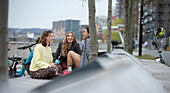 Happy young women talking in city park