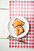 Rye bread with almond butter and pink grapefruit segments