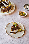 Gluten free pistachio and almond cake with patterned icing sugar decoration