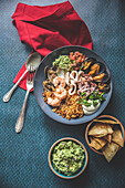 Seafood bowl with rice and mashed avocado