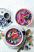 Blueberry smoothie bowls with frozen berries, bananas and figs