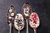 Chocolate spoons with toppings